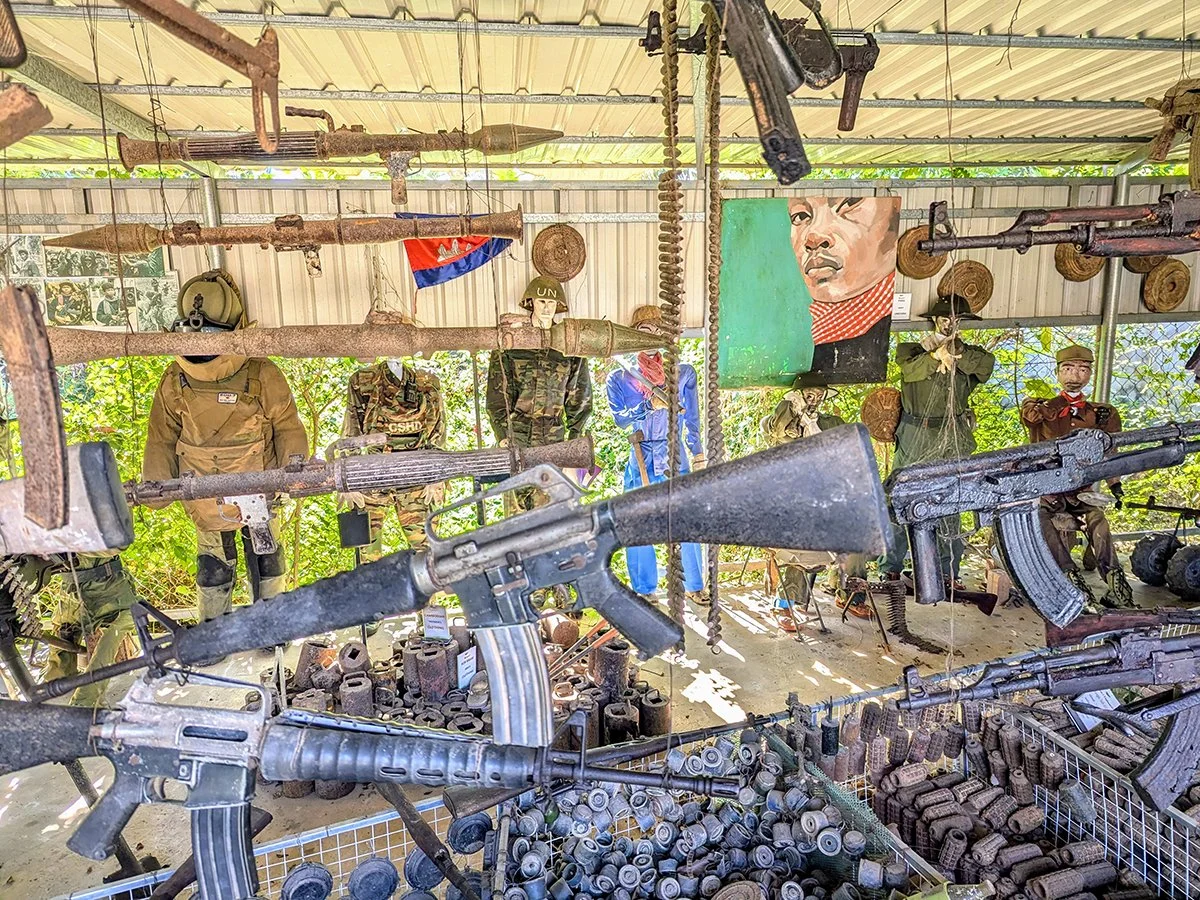 Guns, landmines, and other military equipment on display at the Cambodia Landmine Museum founded by Aki Ra, Phumi Khna, Cambodia (2025). Photo by Danny With Love.