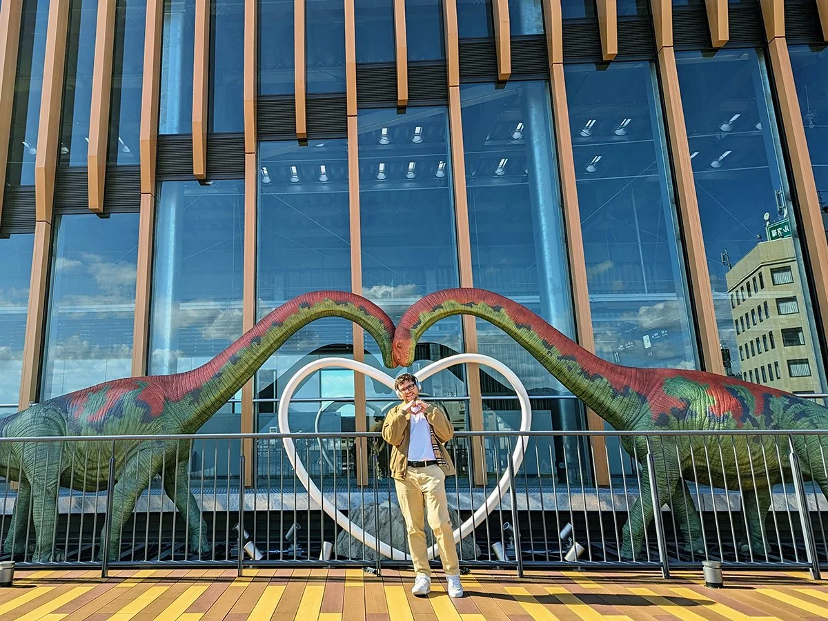 Posing with Fukuititan dinosaurs on the Rooftop Deck at Fukui Station, Fukui, Japan (2023).