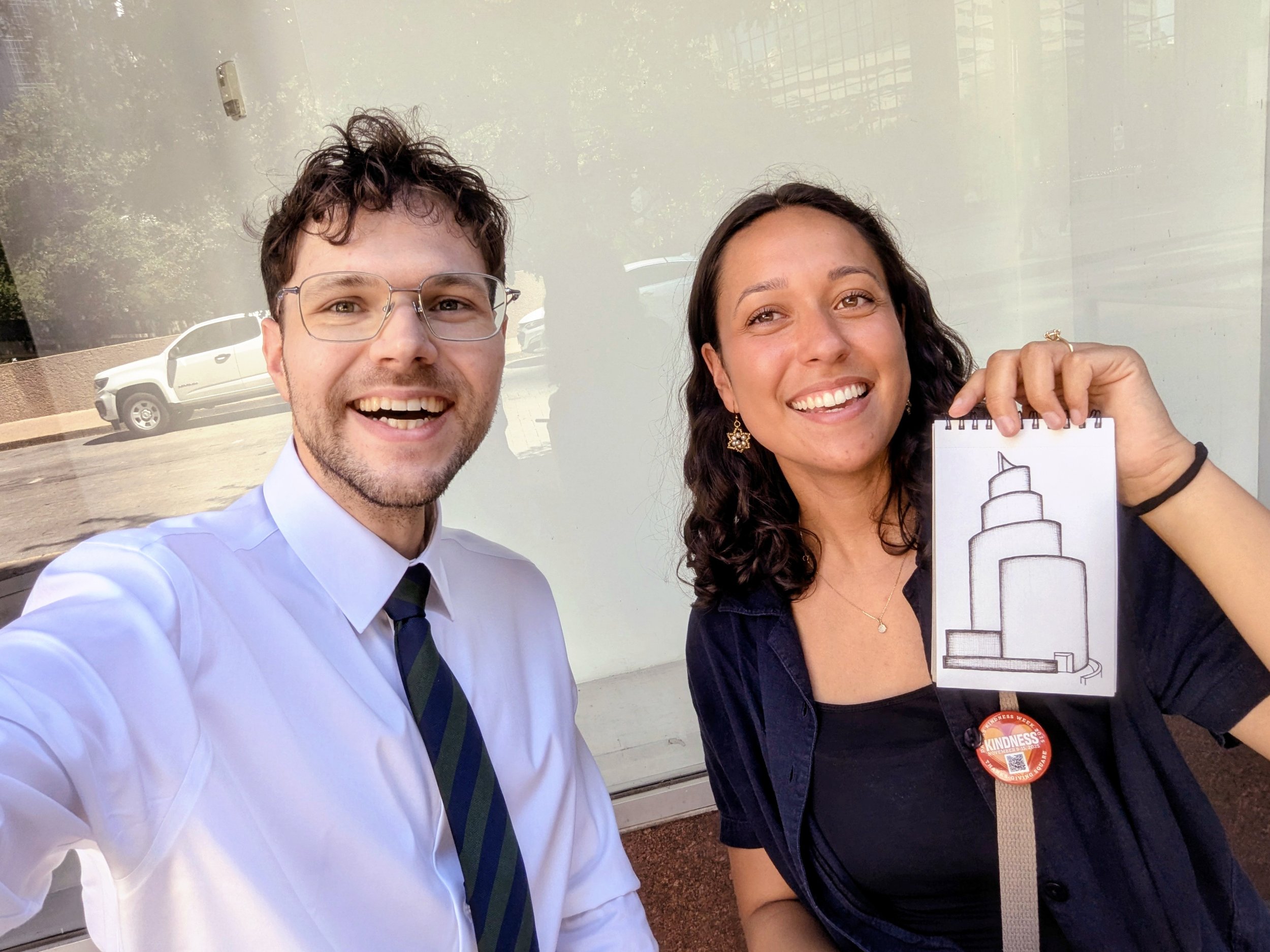 Posing with illustrator Alena Niehaus holding her sketch of Thanks-Giving Square, Dallas, Texas, United States (2026). Photo by Danny With Love.