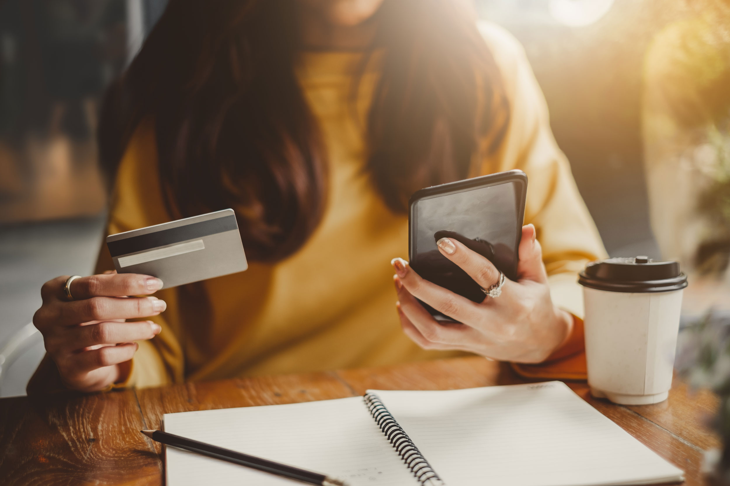 woman-holding-phone-and-debit-card.jpg