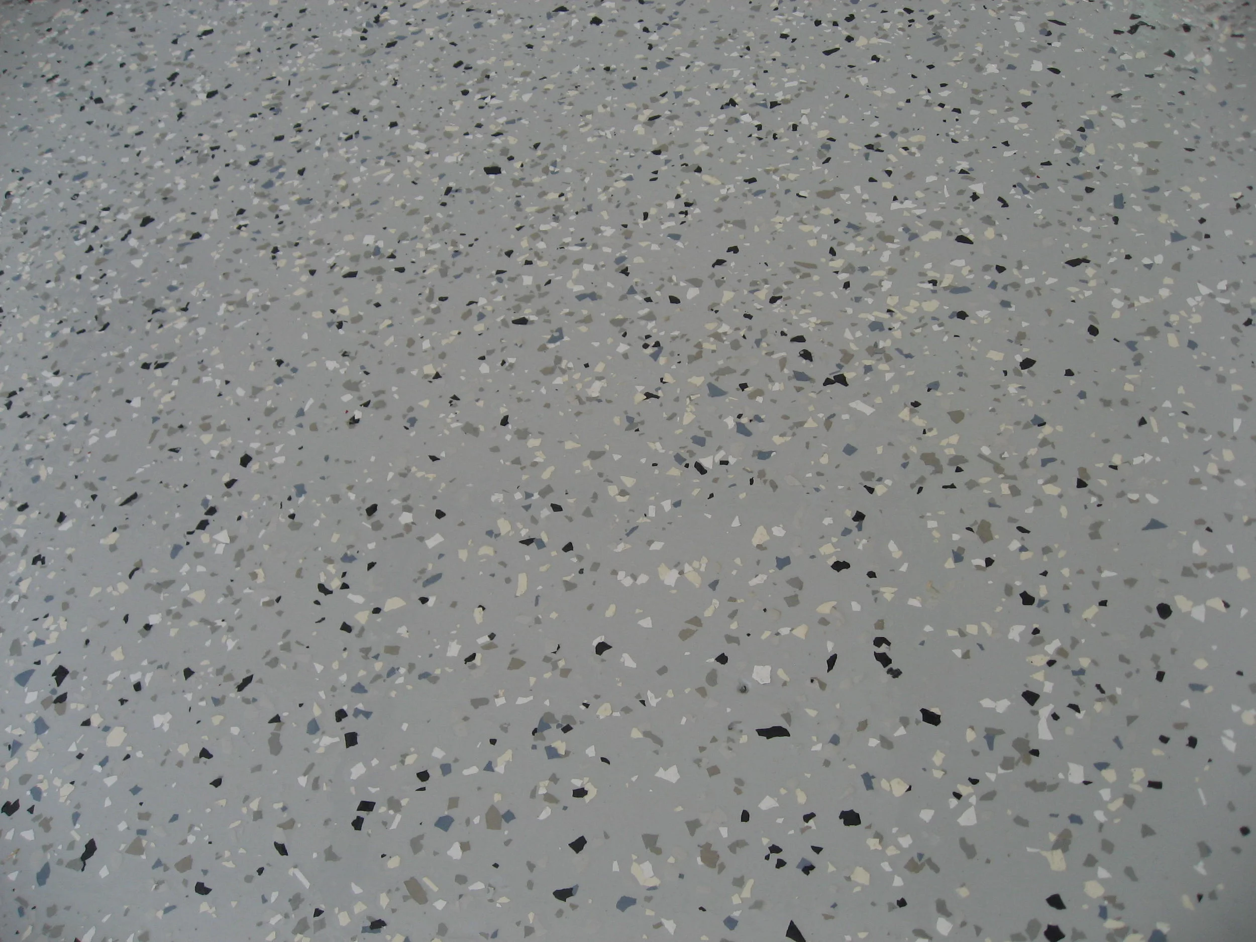  Three coat epoxy color chip system, gray basecoat, 1/4” color flake, custom color chip blend 