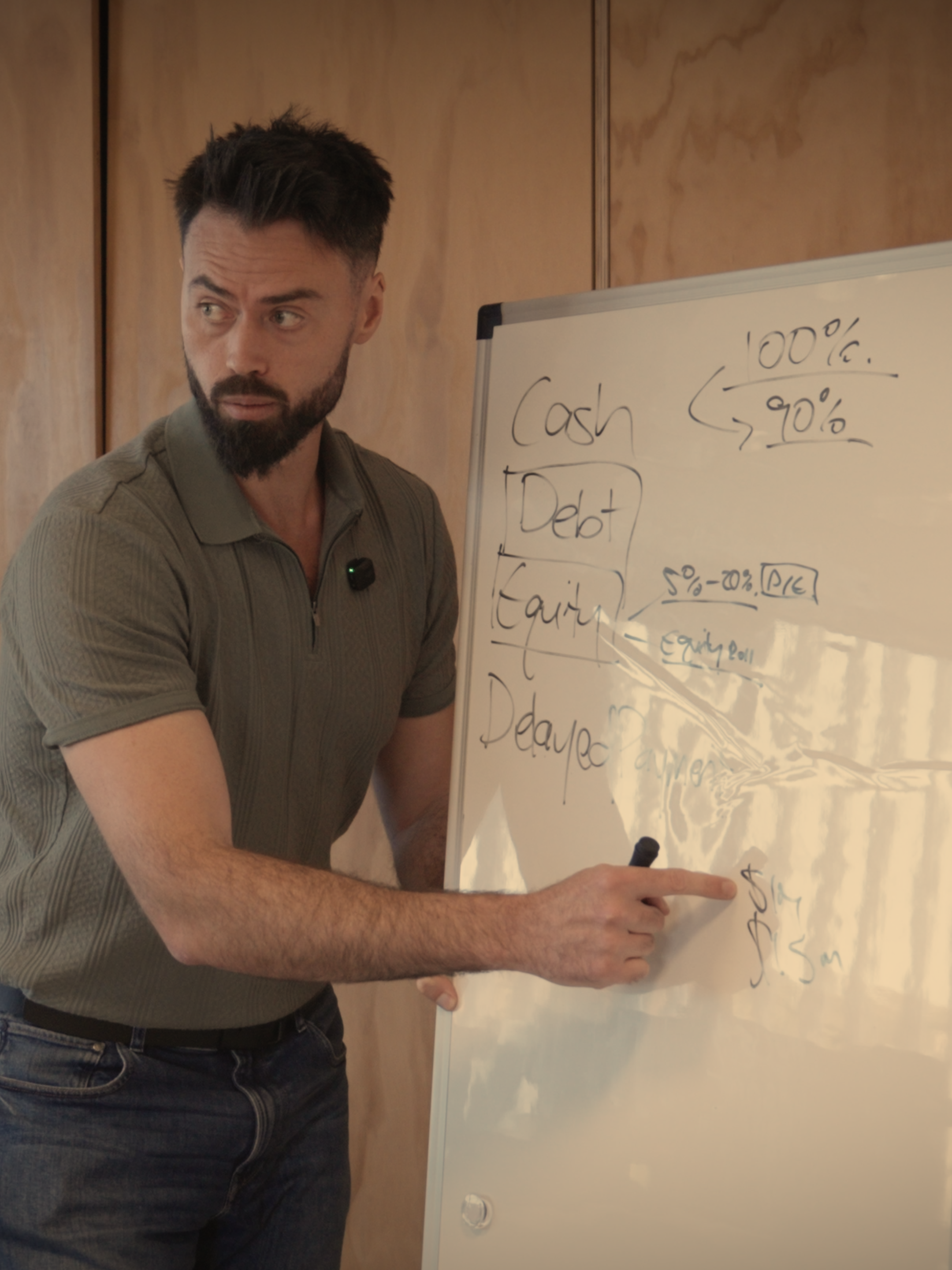 Brandon Lipman explaining deal structures at a whiteboard