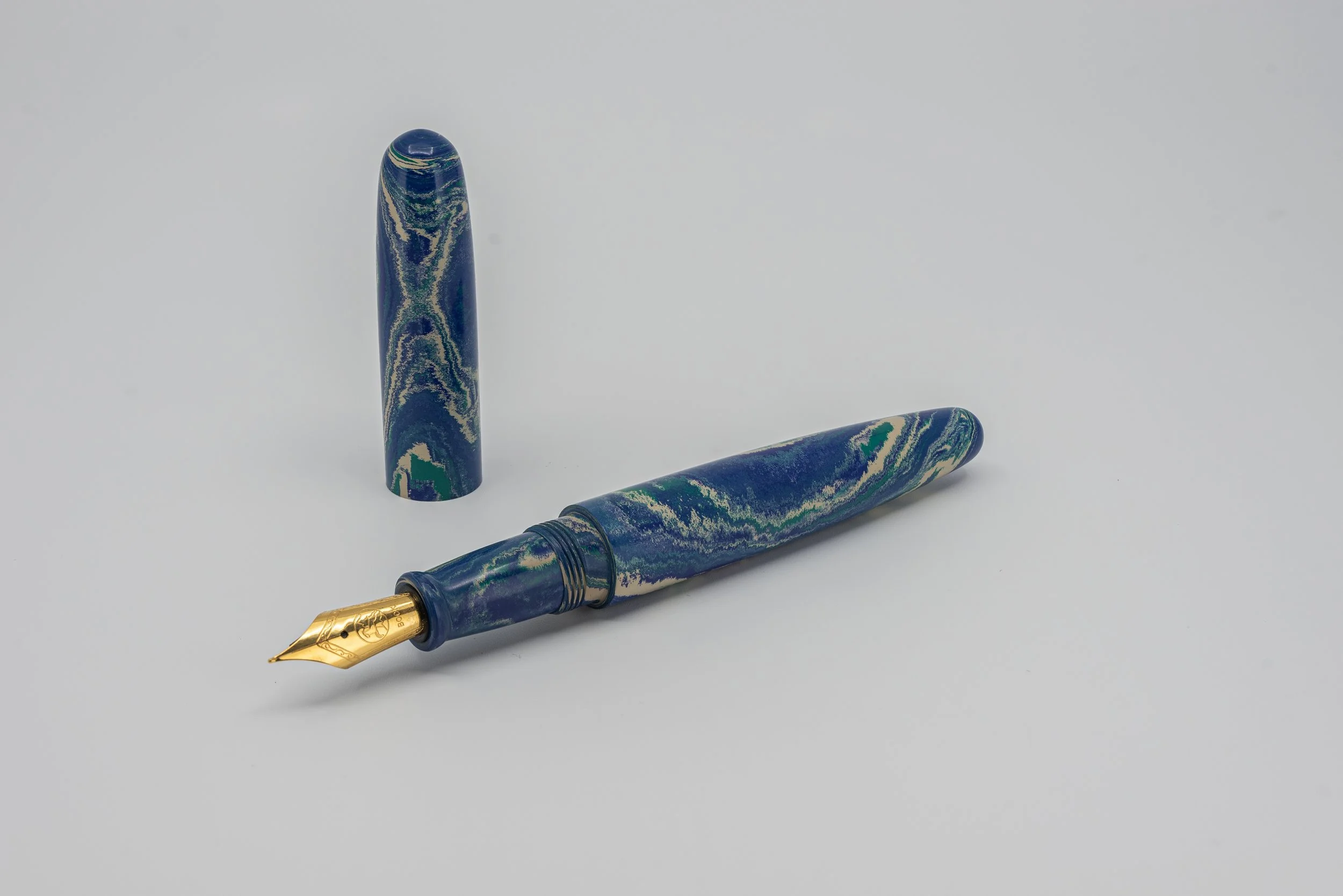 Clyde pen company Blue green and white Ebonite fountain pen.jpg