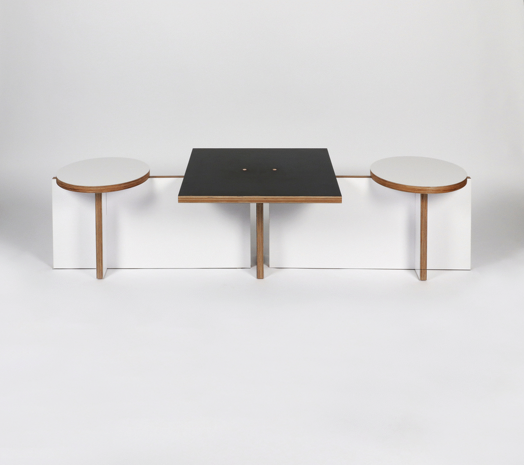 Modern minimalist table with two attached round seats and black tabletop against a plain white background.