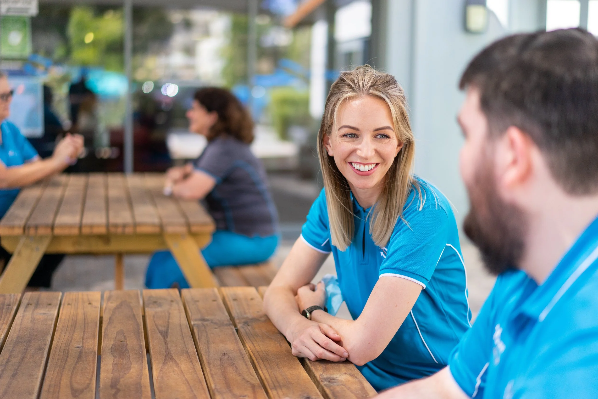 a photo of a woman smiling at a coworker
