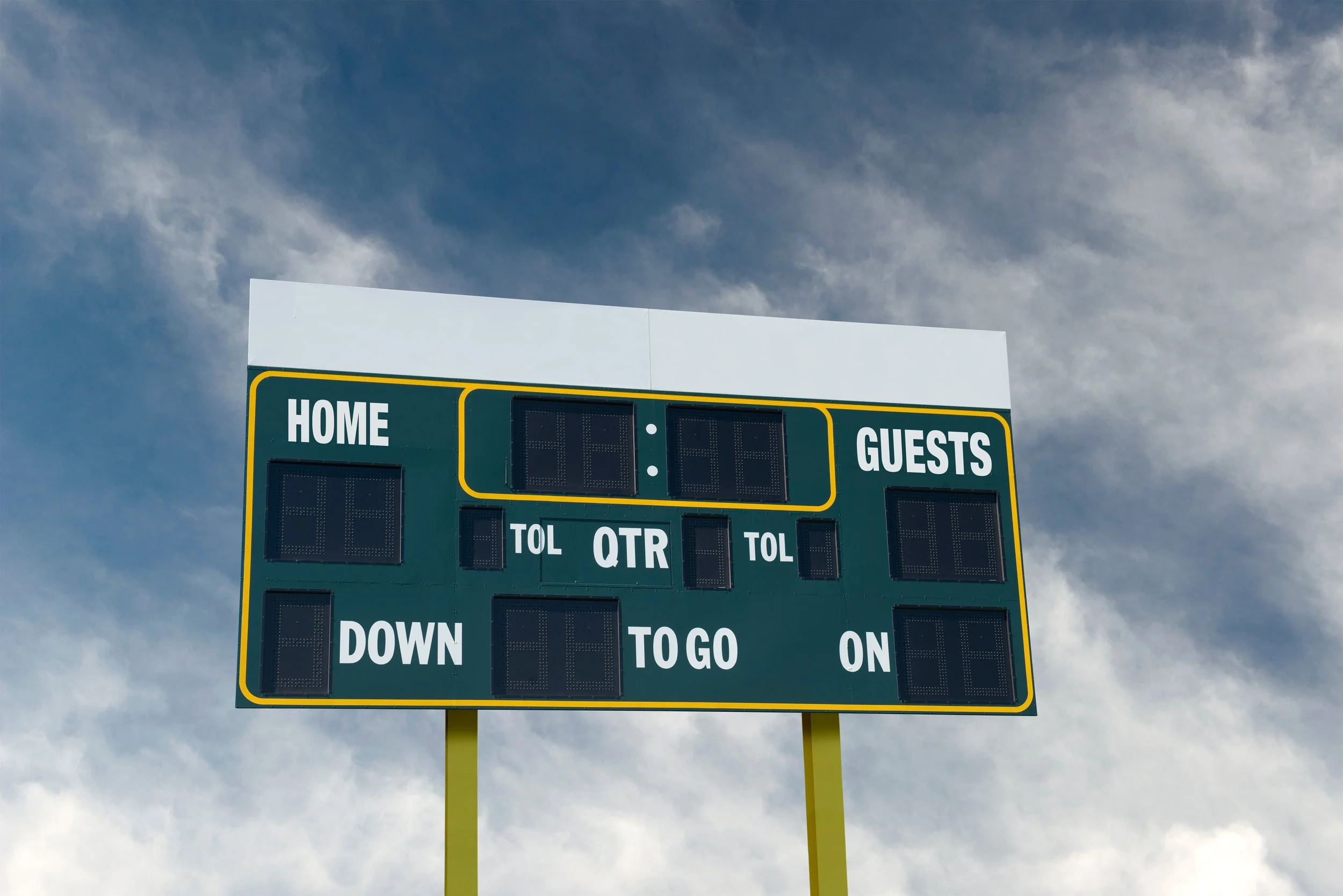 Image of an outdoor scoreboard with a blue sky in the background
