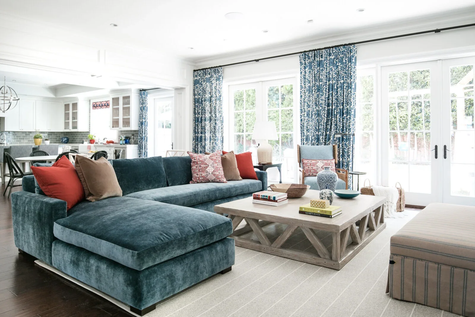 Family-Room-Interior-Design-French-Doors-Rustic-Coffee-Table-Blue-Couch-Perfitt-Richards.webp