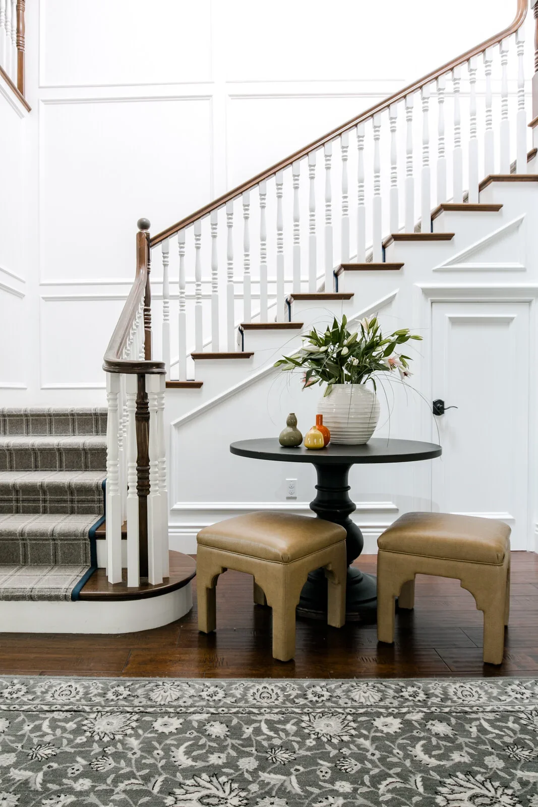 Traditional-Staircase-Landing-Paneled-Walls-White-Newel-Post-Wood-Bannister-Railing-Perfitt-Richards.webp