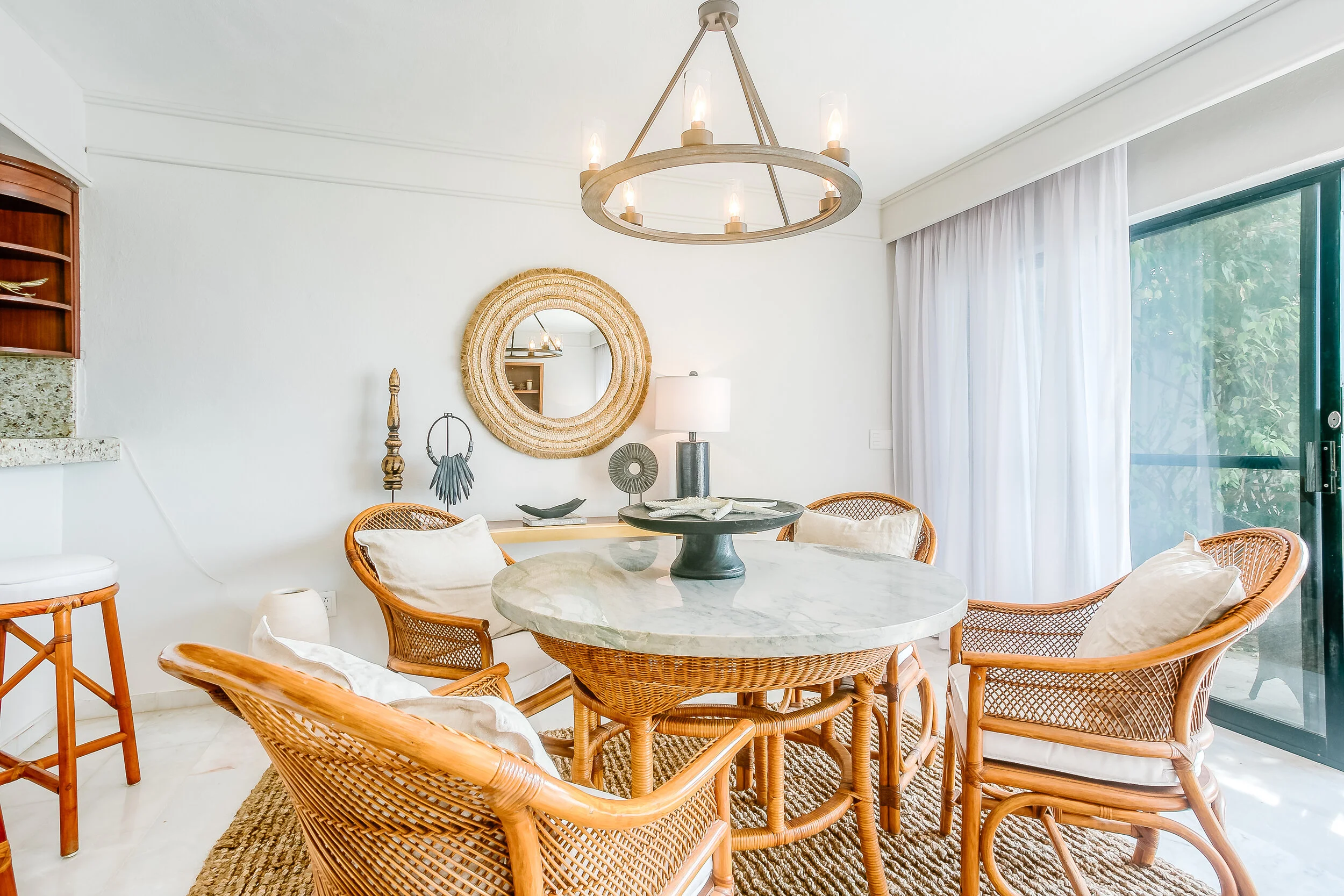 The dining room with refinished/reupholstered cane-style dining table and chairs.
