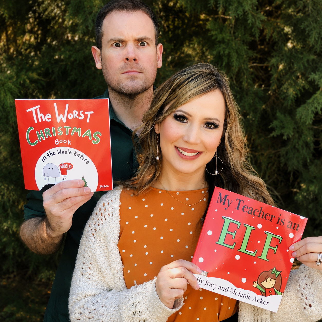 Joey and Melanie Acker holding children's books from the Ackers' Books collection.
