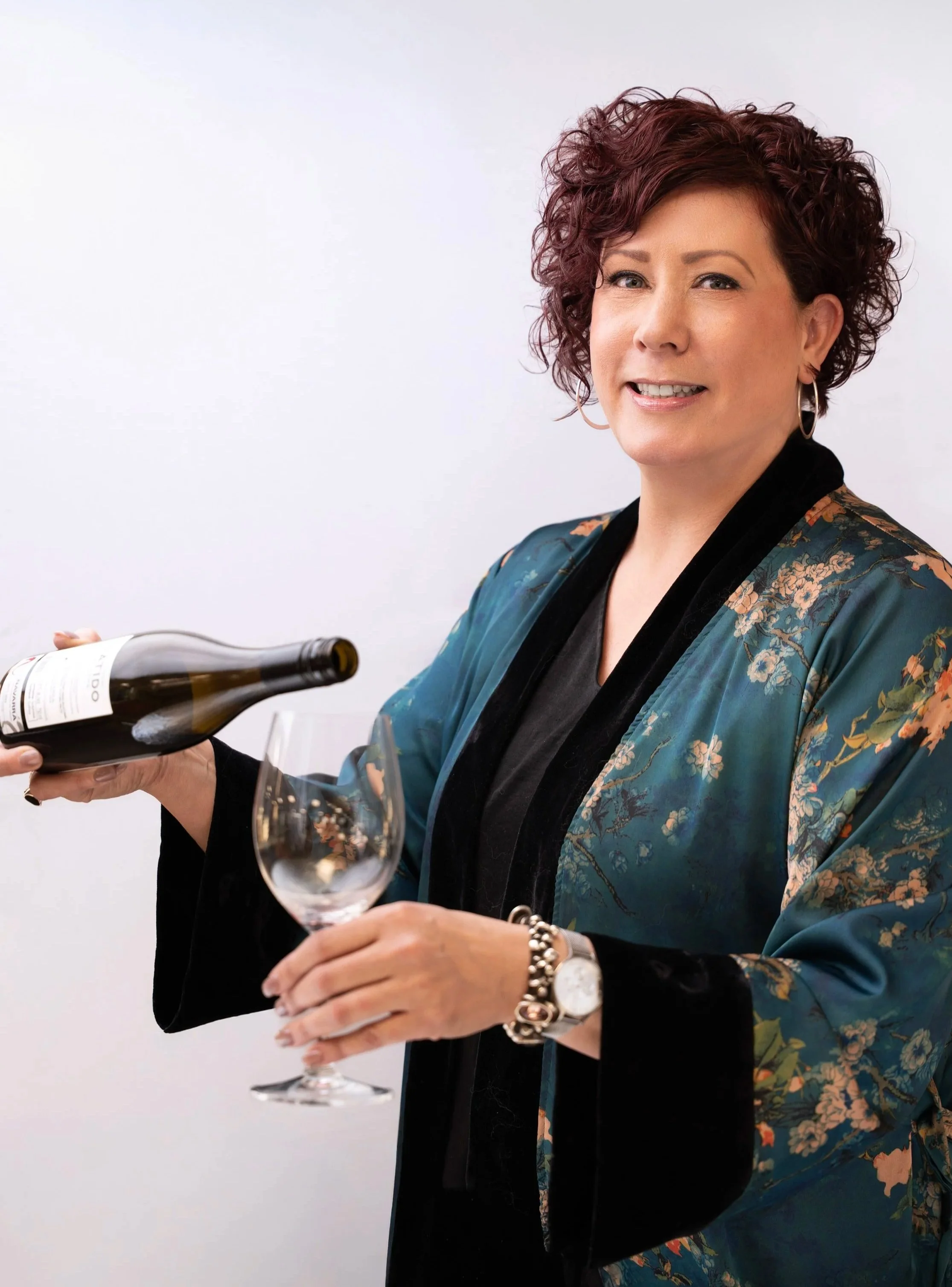 Heather pouring a glass of wine