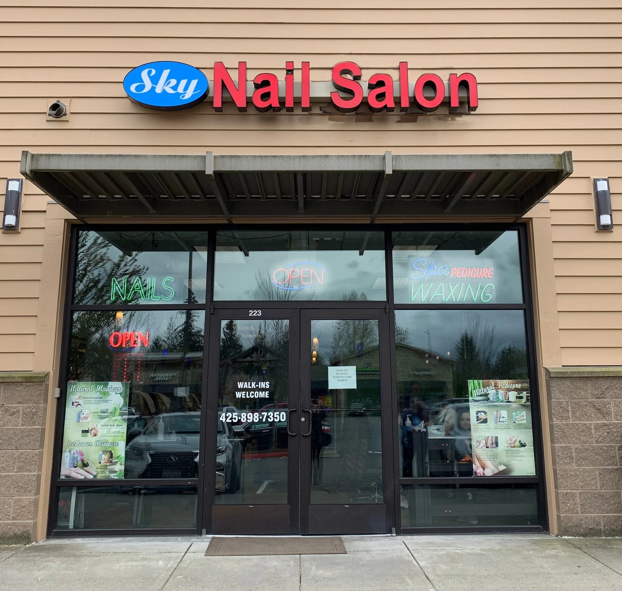 the door to Sky Nail Salon with an open sign lit showing customers what to look for when they arrive