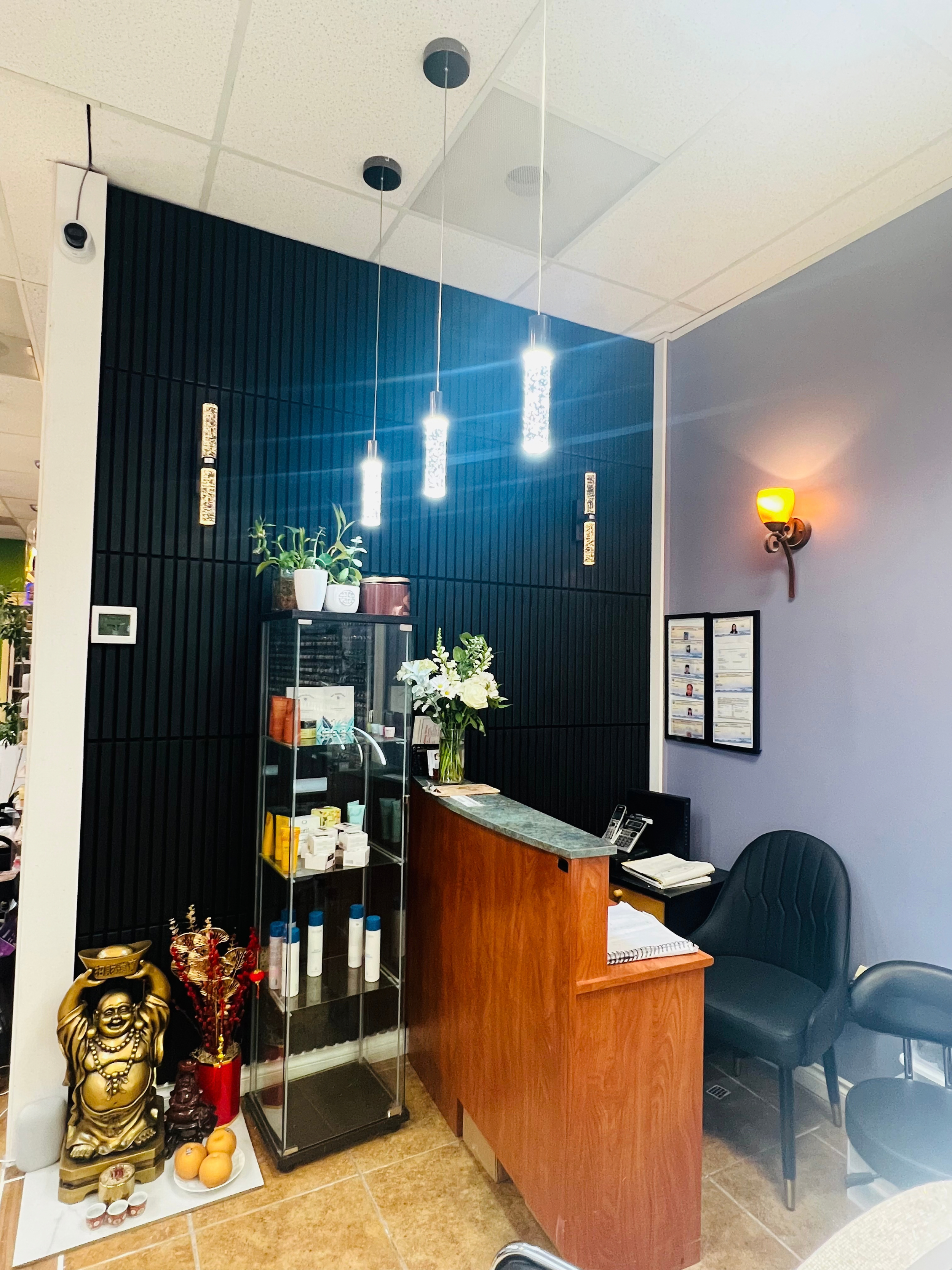 Counter where guests check in and pay. There is some nice lighting, a Buddha, and some plants