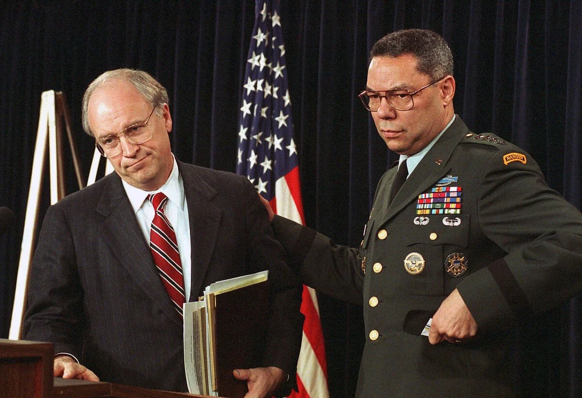 Defense Secretary Dick Cheney, left, appears at a war briefing at the Pentagon on January 17, 1991 announcing loss of an American warplane in the attack on Iraq. At right is General Colin Powell, chairman of the Joint Chiefs of Staff. Dennis Cook / …