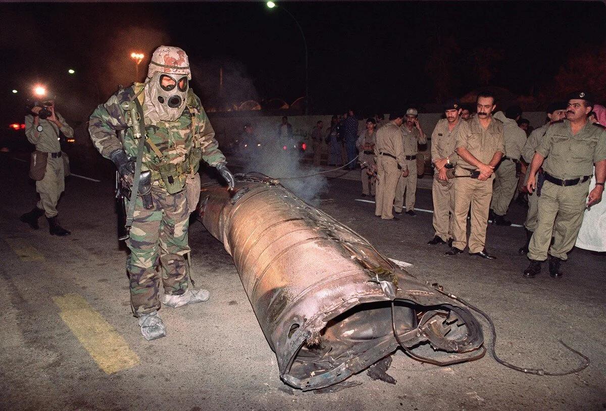 A U.S. soldier and Saudi police officers examine the wreckage of a missile, believed to be a Soviet-made Scud, which landed in downtown Riyadh, Saudi Arabia, on January 22, 1991 when Iraq launched a missile attack on the Saudi capital. Pascal Guyot …