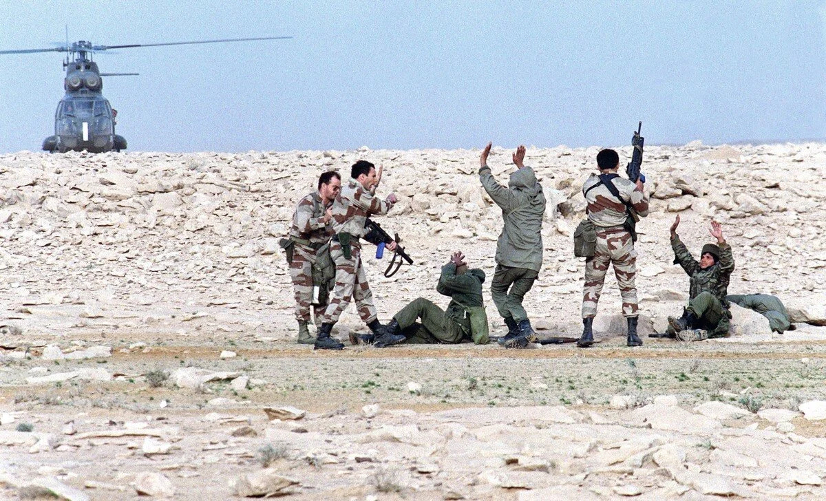 French special-forces commandos capture Iraqi soldiers somewhere in Iraqi desert on February 26, 1991. Mike Nelson / AFP / Getty