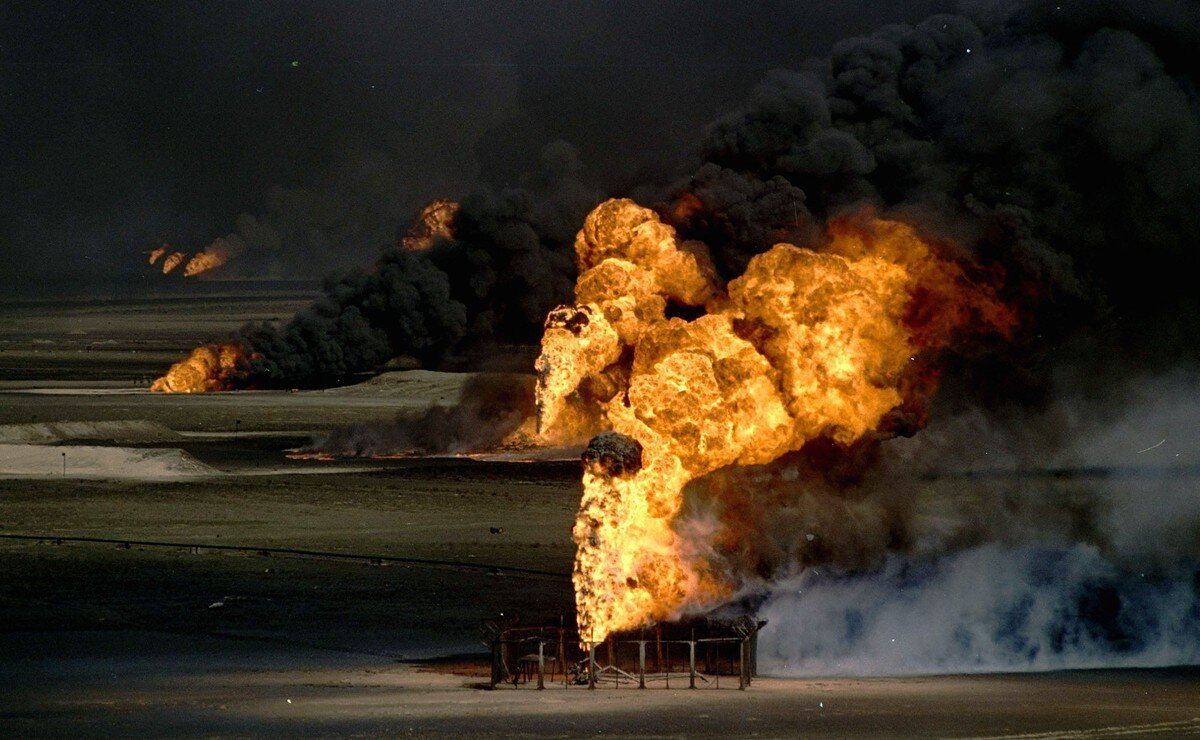 Geysers of flame and thick, toxic smoke spew forth on March 10, 1991, from just a few of the hundreds of Kuwaiti oil wells set afire by fleeing Iraqi troops. Greg Gibson / AP