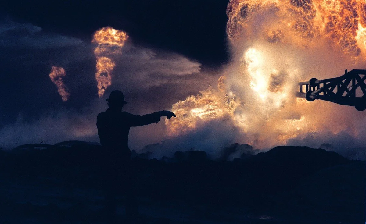 Red Adair’s fire-fighting crews at work on April 1, 1991, beside a blown-out well damaged by retreating Iraqi soldiers in Al-Ahmadi oil field in southern Kuwait. Pascal Guyot / AFP / Getty