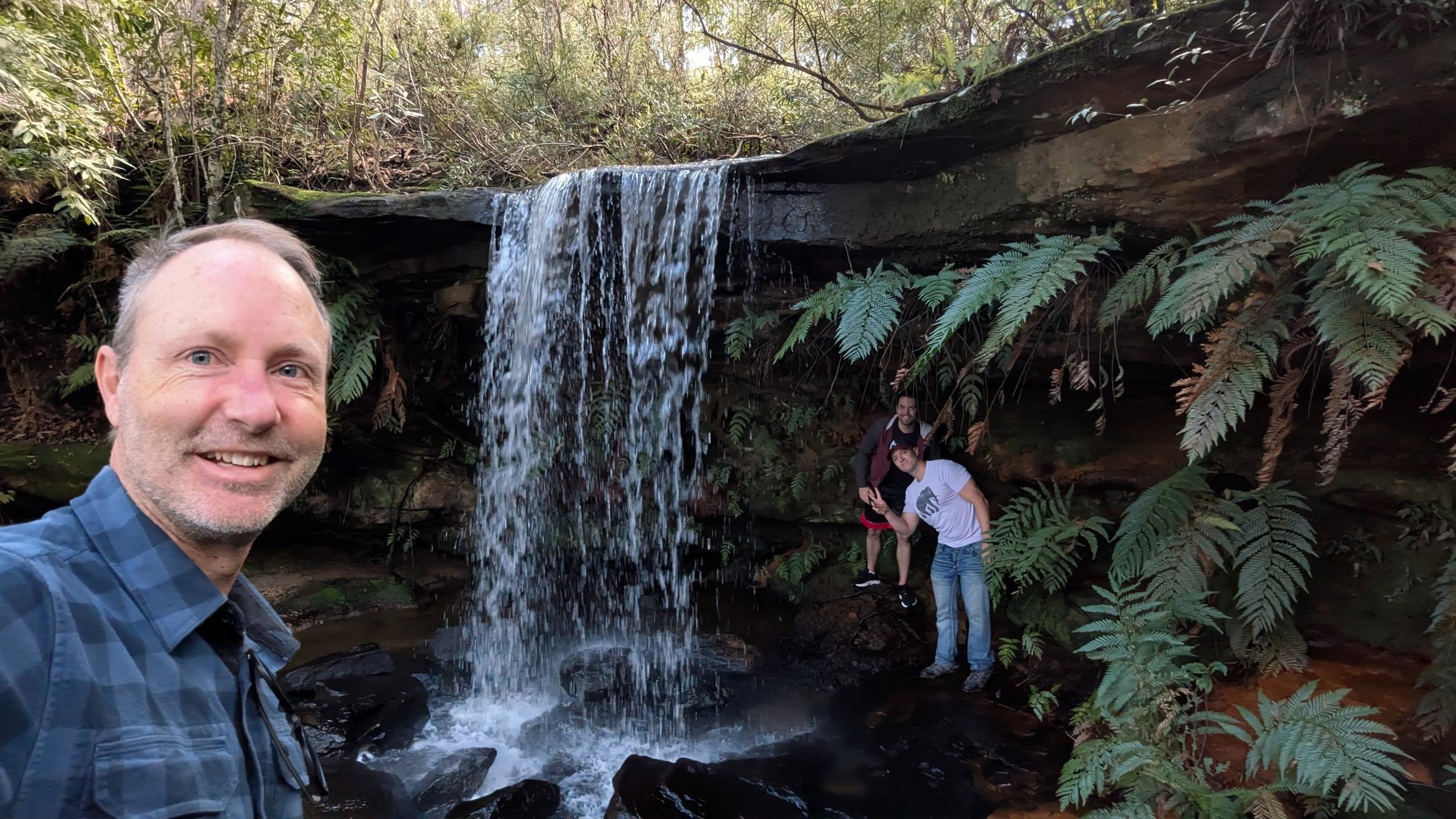Standing under a waterfall on the Girrakool Loop in Somersby
