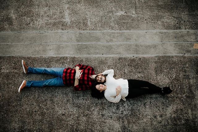 Helen and Zac laying on the pavement, gazing into each other&rsquo;s eyes as lovers naturally do... 😂 this was one of my favorite photos from their session. It reminds me a lot of a couple kids hanging out on the playground without a care in the wor