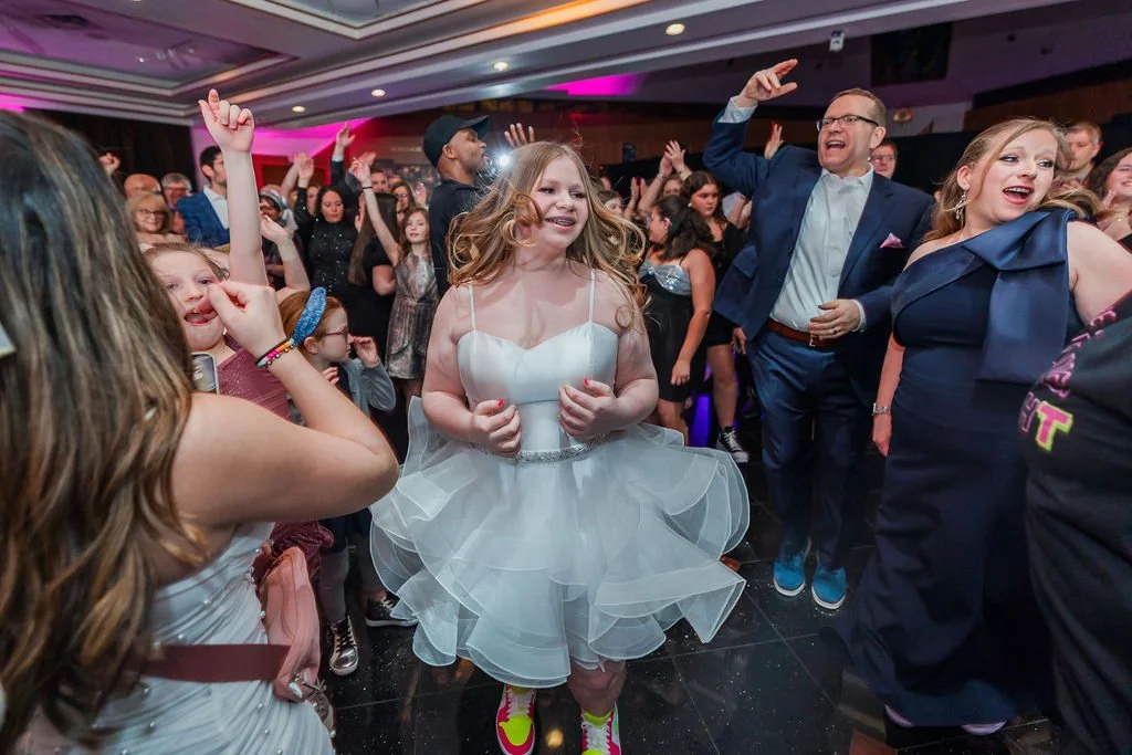 People dancing and enjoying themselves at a lively indoor party or celebration.