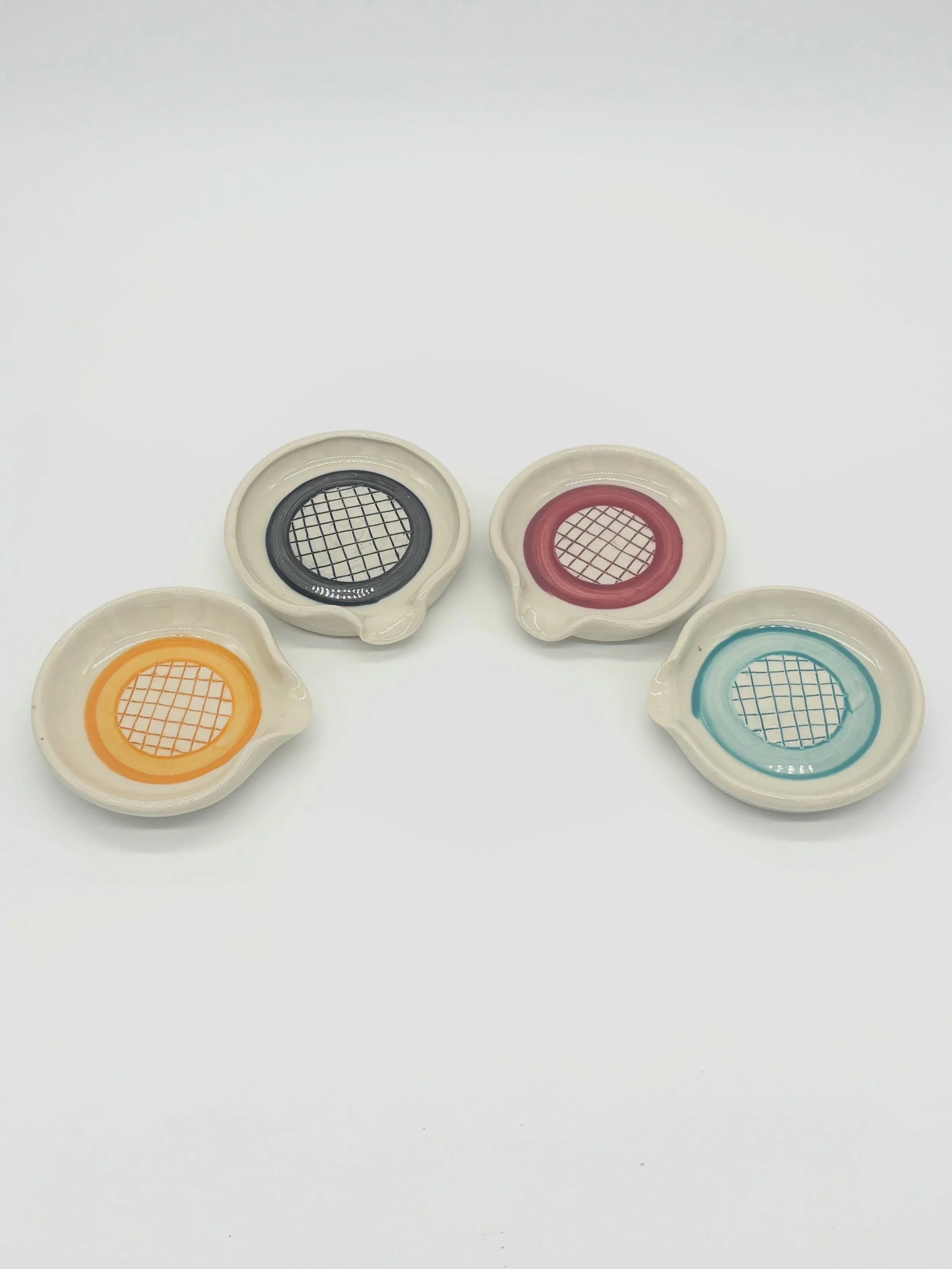 New spoon rests fresh out of the kiln! I am really happy with how they turned out. Every little detail, from painting on the ring of color, the grid, the size, and the spout, worked out and I am so pleased. I think they&rsquo;ll look beautiful on any