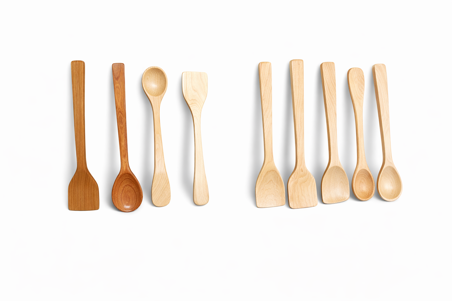 Six wooden kitchen utensils, including spatulas and spoons, arranged on a white background.