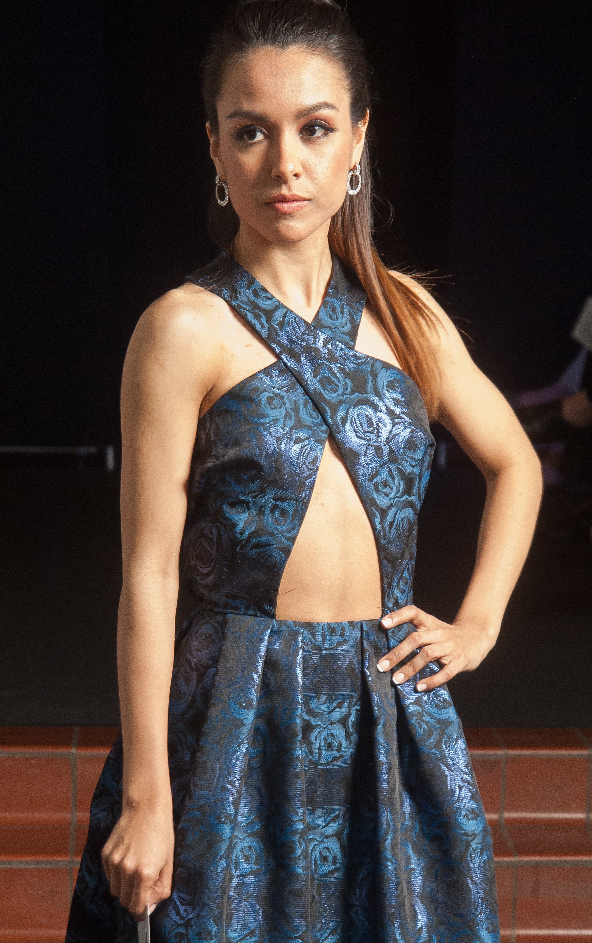 Model wearing navy blue cross-neck dress.
