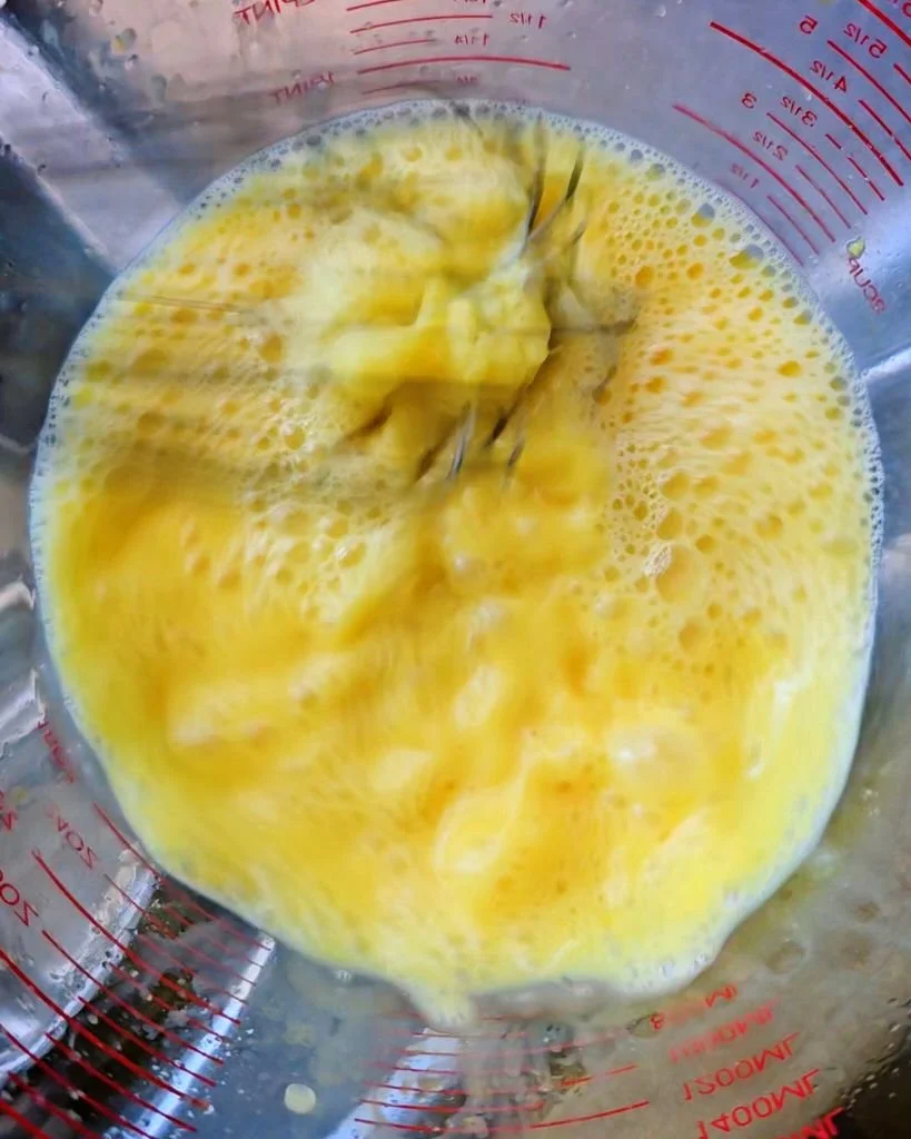 Whisking the egg + lemon mixture