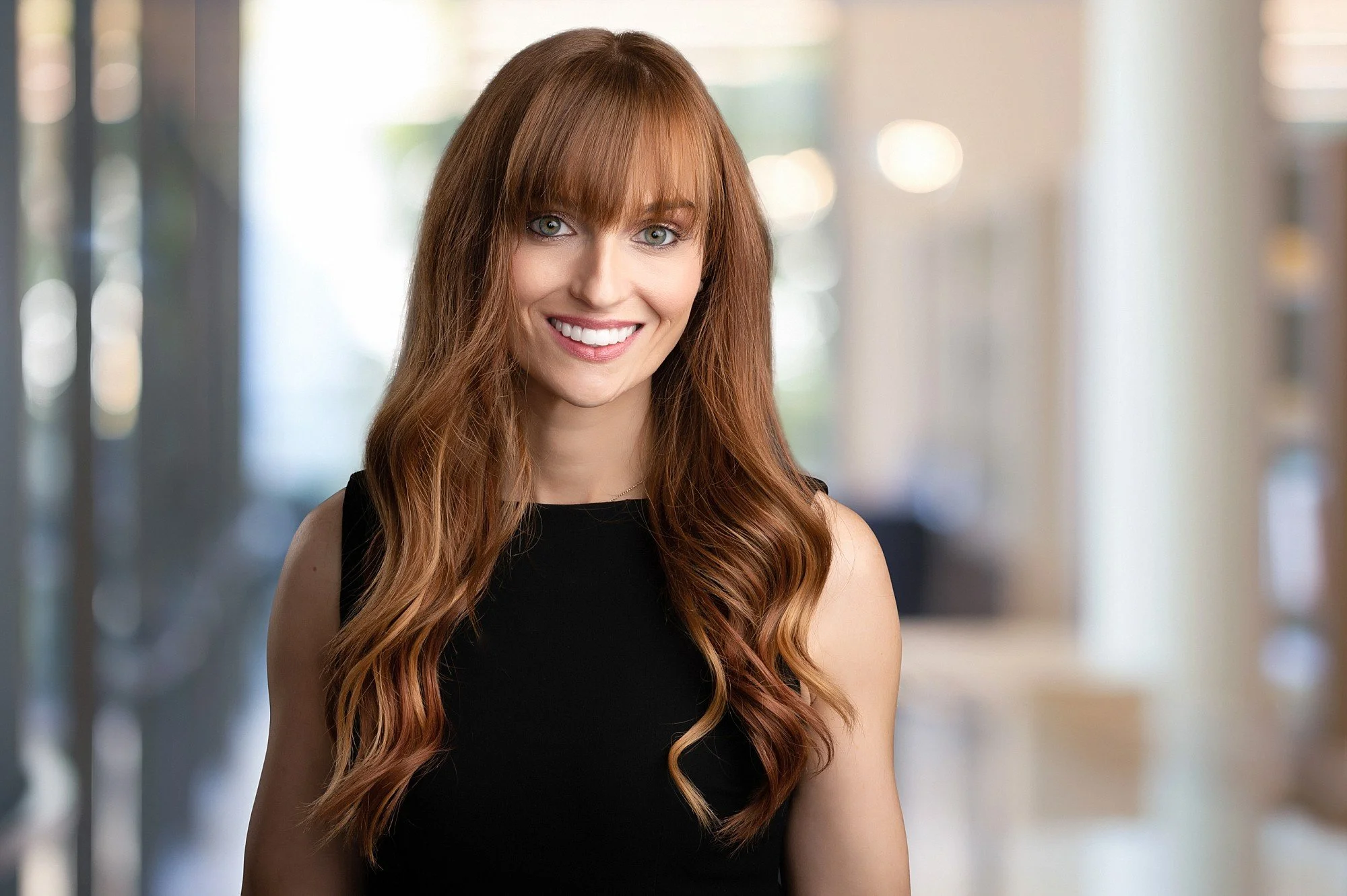 rofessional woman's headshot with a modern office background, photographed by Victoria BC headshot photographer Erin Clayton