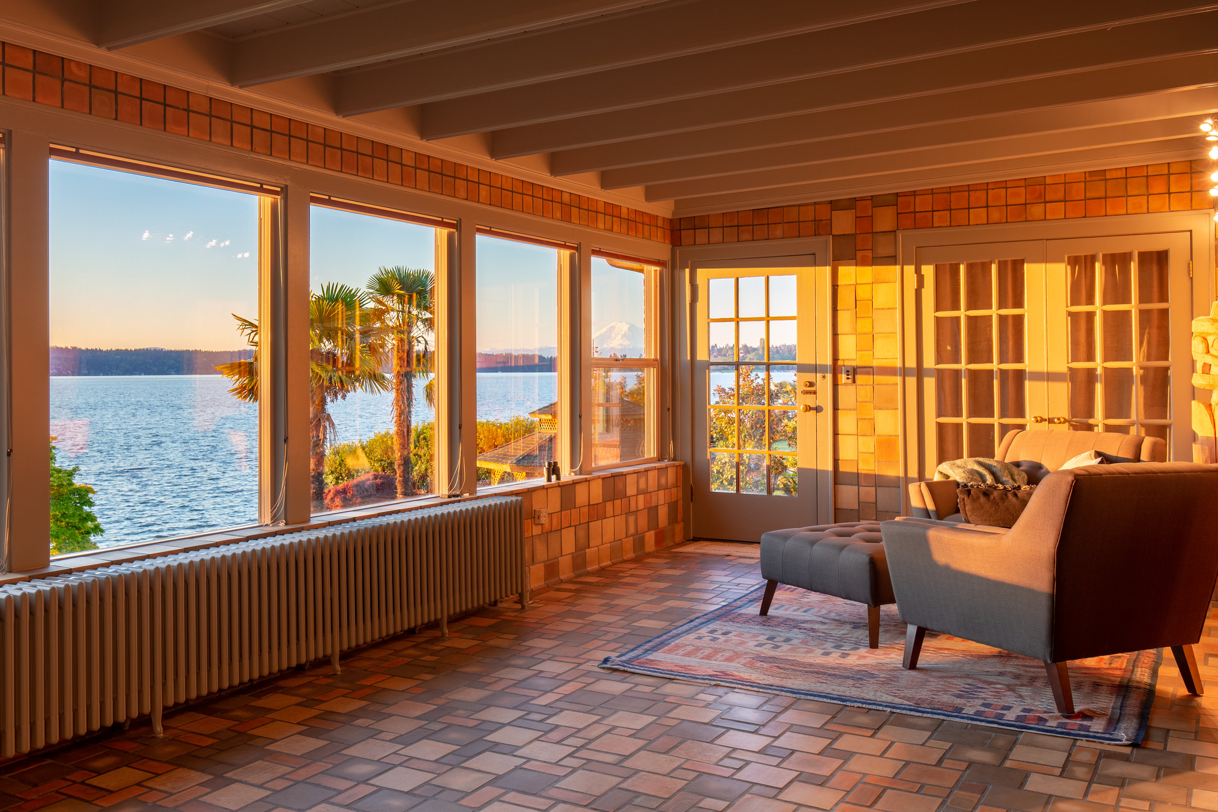 Sunroom with wall of windows framing Mt Rainier