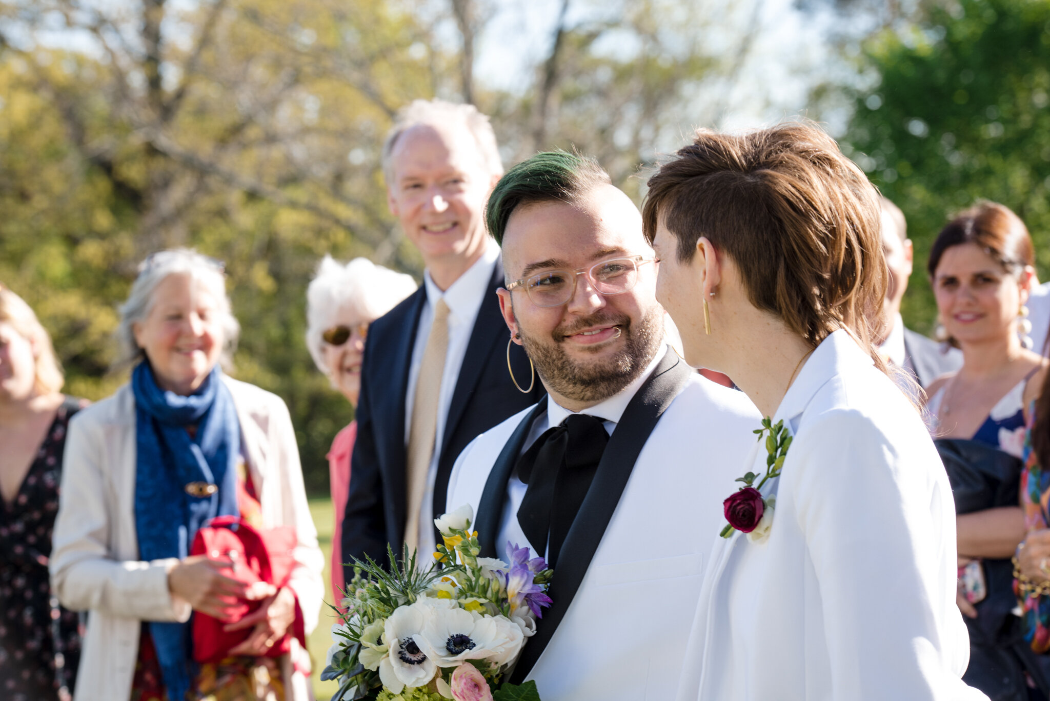 Marriers smile at each other as they walk into ceremony at Roger Williams Botanical Center Providence Rhode Island Michelle Schapiro New England LGBTQ Photographer