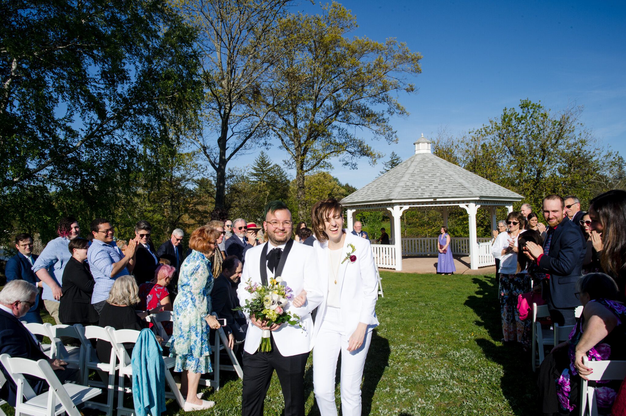 Newlyweds exit ceremony arm in arm at Roger Williams Botanical Center Providence Rhode Island Michelle Schapiro New England Couple Photographer