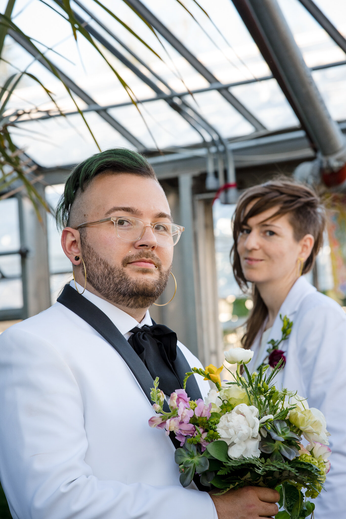 Marriers in white suits in greenhouse after ceremony at Roger Williams Botanical Center Providence Rhode Island Michelle Schapiro New England Photographer