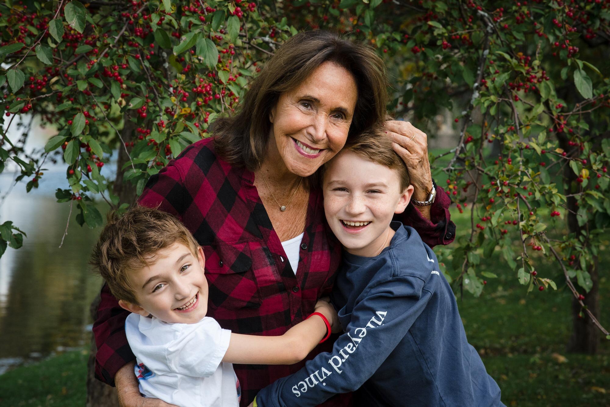 Grandparent and two young kids hug during family session in Boston park Michelle Schapiro Photography