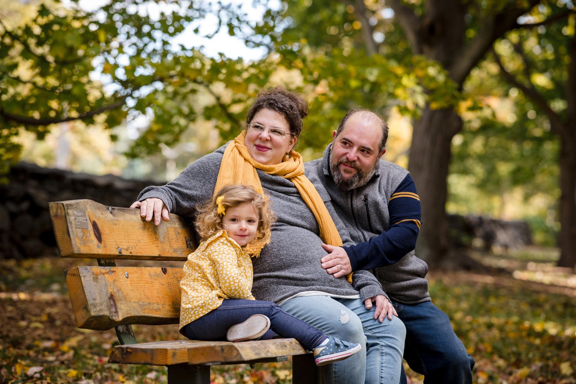 Expectant parents cradle belly during autumn pregnancy photo session in New England Michelle Schapiro Family Photography