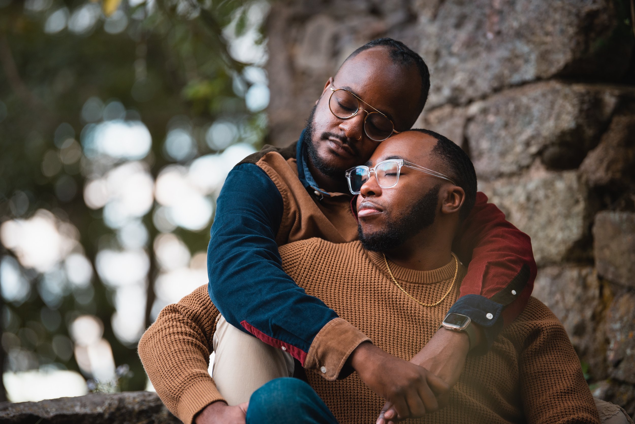 Black gay couple embraces during couple portrait photoshoot in park in boston by Michelle Schapiro LGBTQ Photography