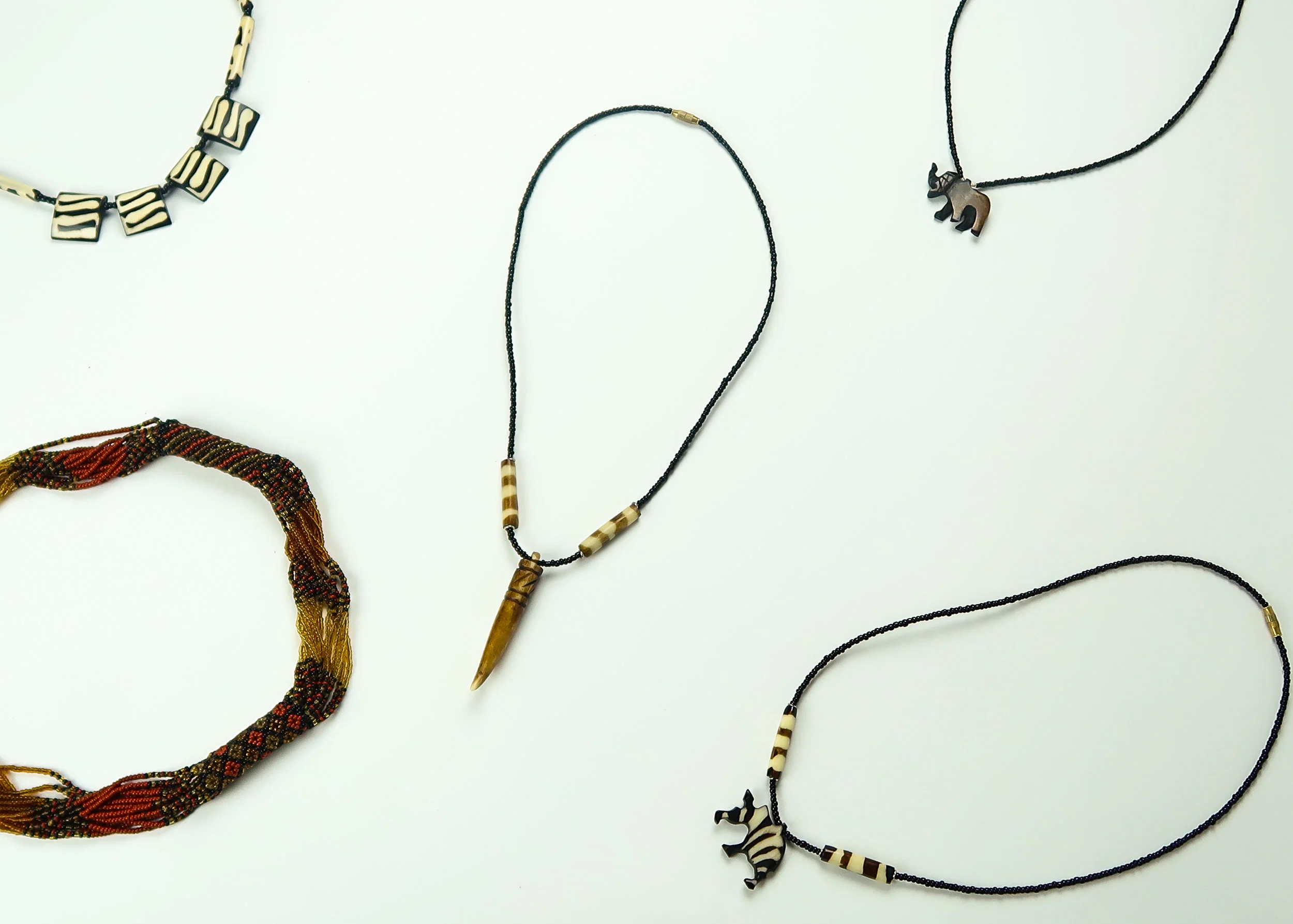 Mom’s Necklace As I got older, my mom gave me more freedom to express style and beauty. She gave me the necklaces in this image a year before my family moved to South Africa from Atlanta. Her style continued to influence me, the things she gave me shaped my look today. The designs of the necklaces inspired the dots, triangles, intense graphic designs of my make up.