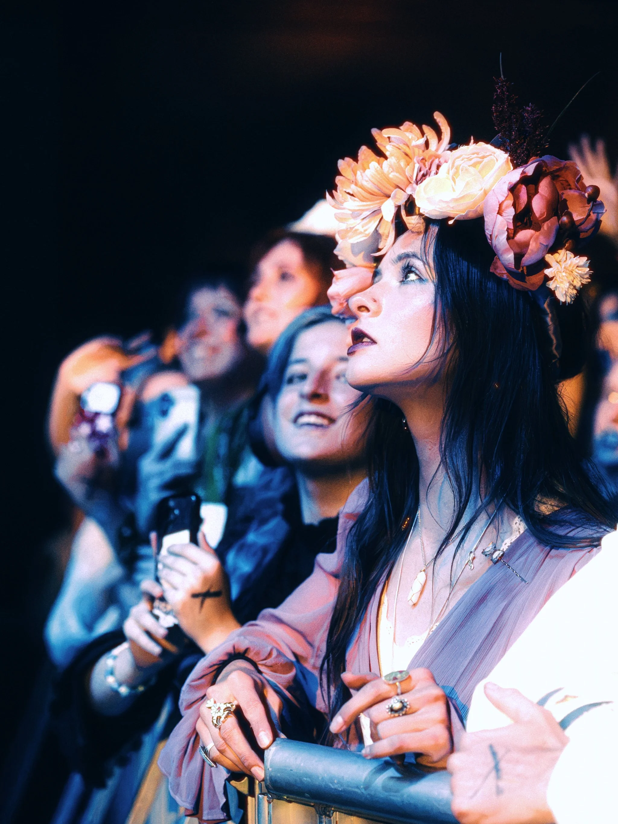 Fans in flower crowns pressed to the barricade at the Ogden, watching Paris Paloma