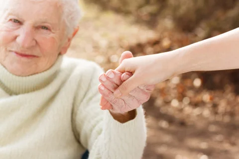 bigstock-Senior-Woman-Holding-Hands-Wit-70275082-480x320.jpg