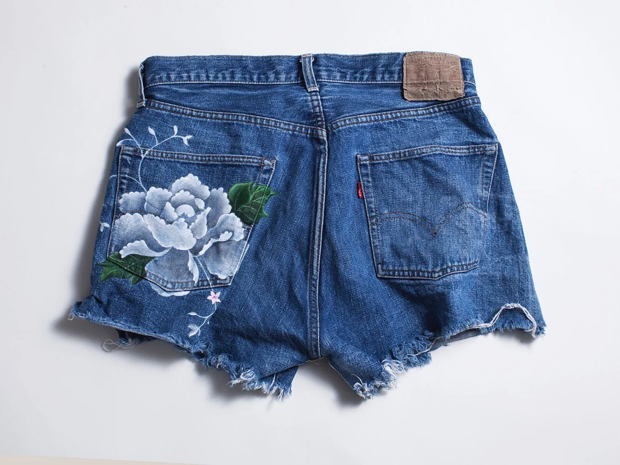 Vintage denim jeans with custom painted flower 