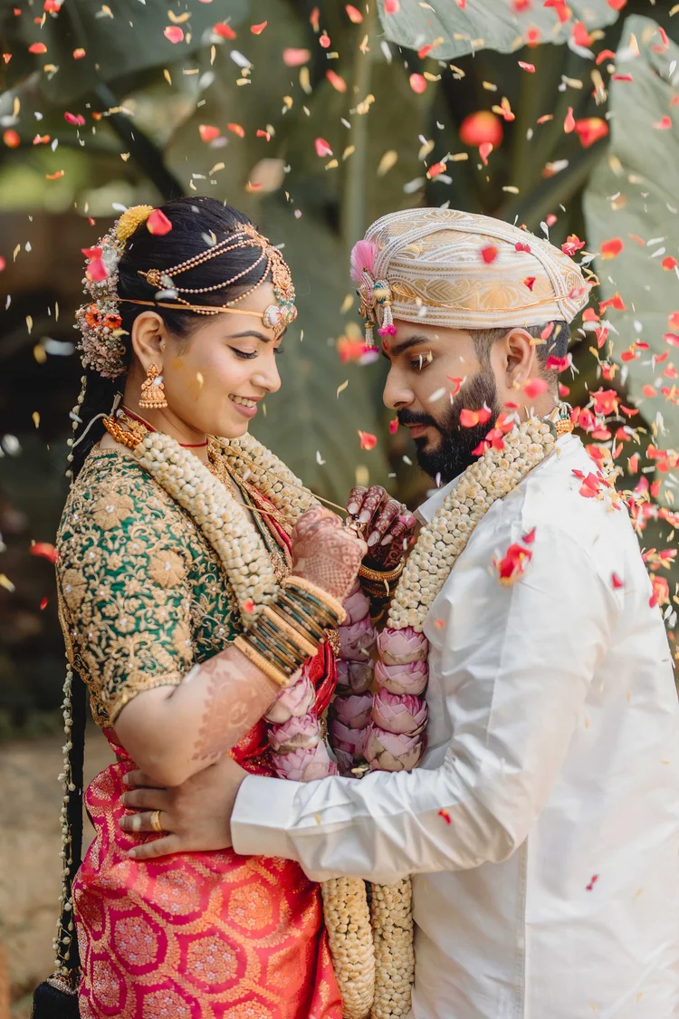Couple under a shower of flower petals