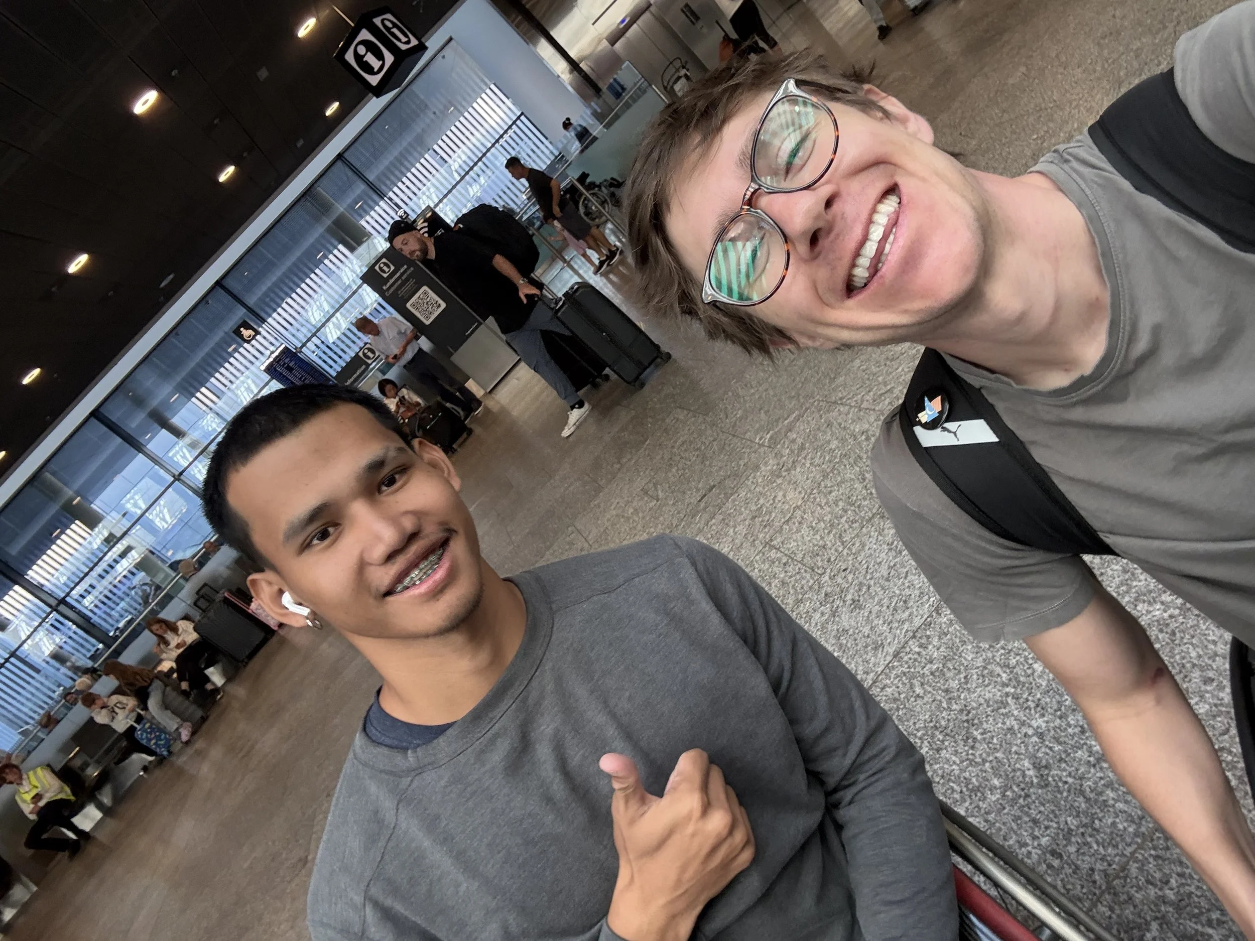 Sam, smiling while taking a selfie with Thai athlete Paeng-Nuea Athiwat.