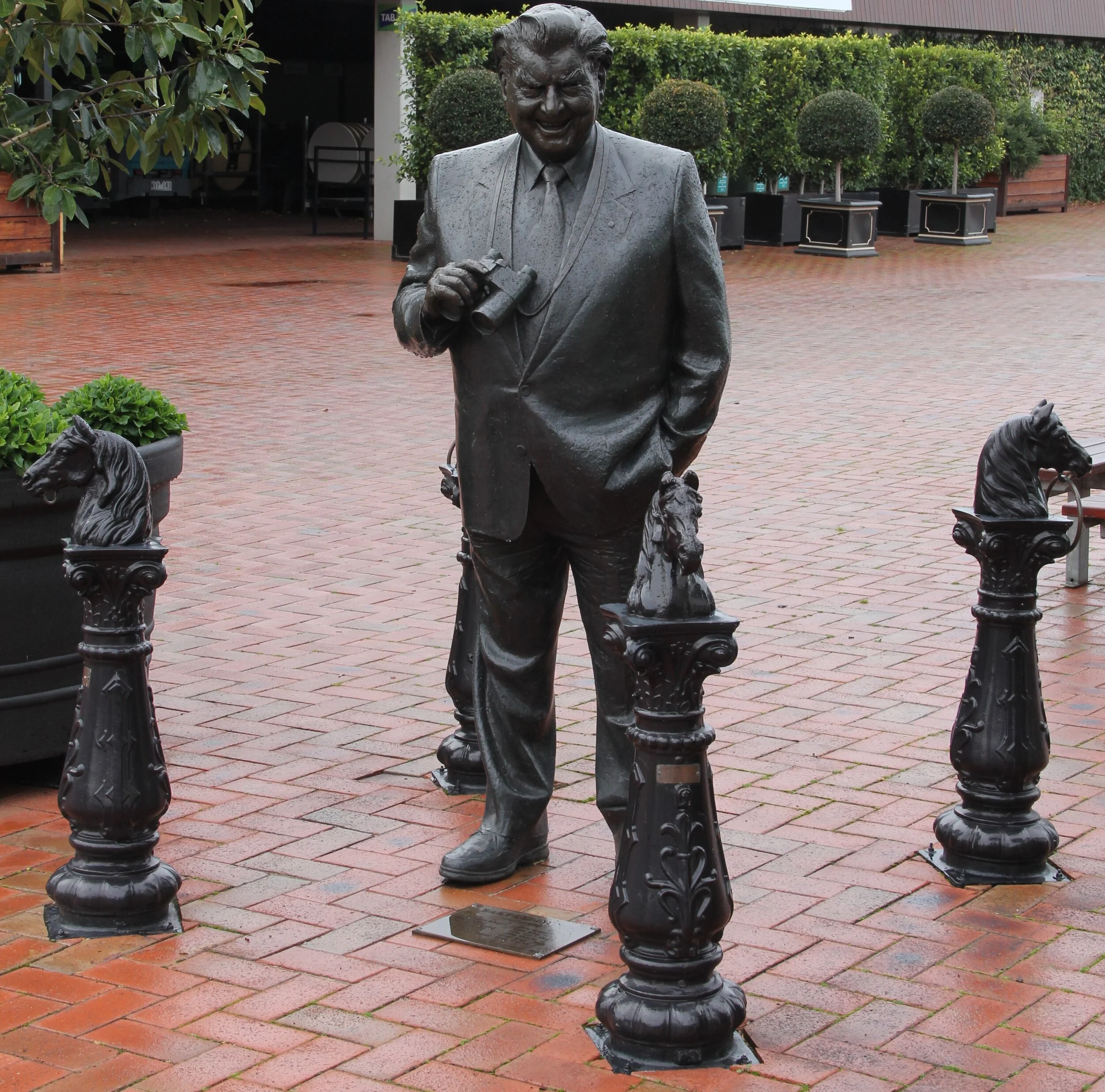 The Cups King’s statue has been moved since we took this photo and sadly the horse-head bollards did not make the journey with him. Dedicated around 2000, the statue made the move from the Betting Ring to the front of the Grand Stand in 2016 when the old 1920’s Members stand was demolished to accommodate the luxurious new members grandstand which opened in October 2018.