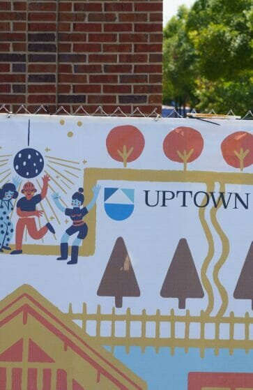 Uptown Atlanta logos on a construction fence.