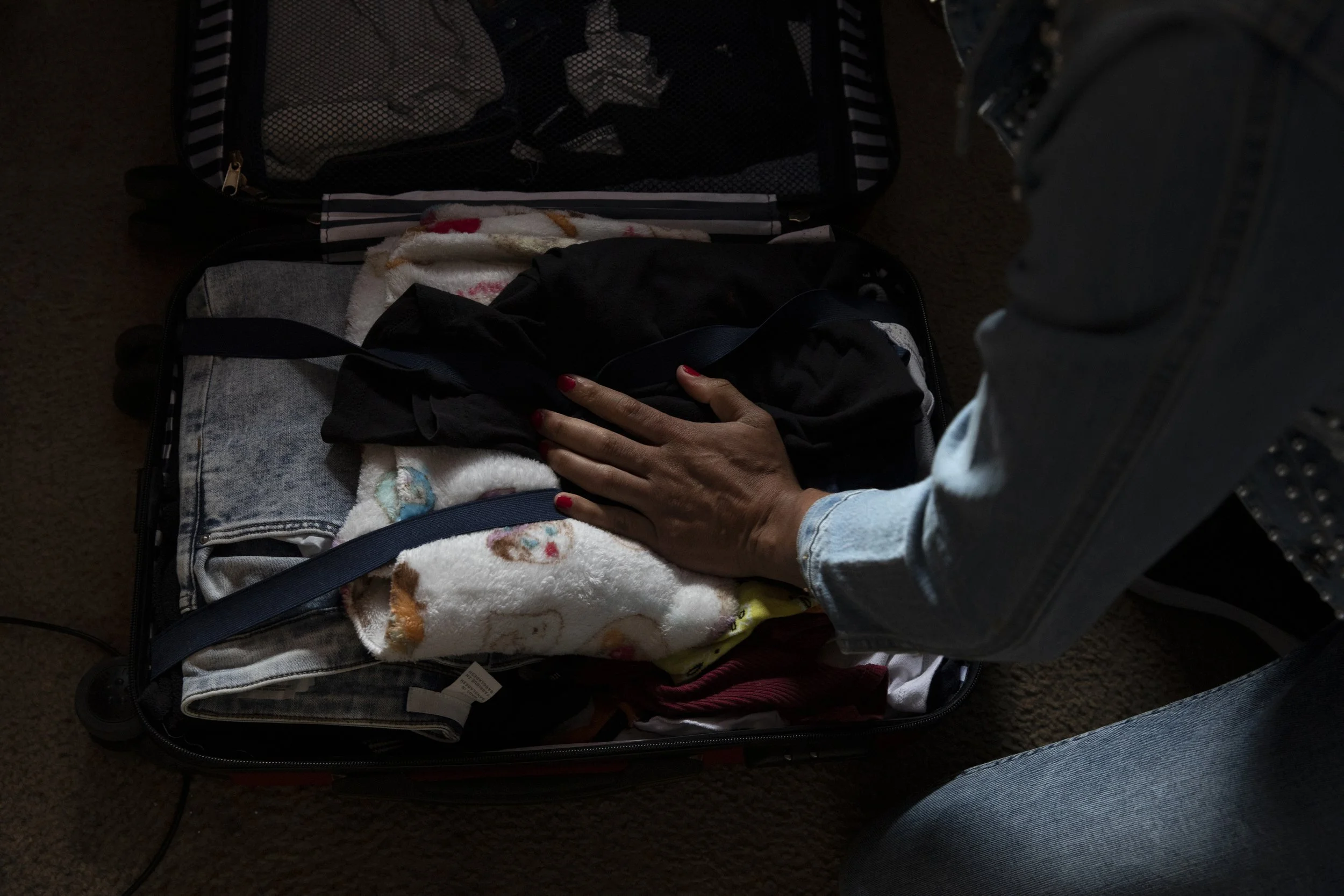  Zethare finishes packing on her last day at Jardín de las Mariposas. She’d painted her fingernails the night before in preparation for the journey to the border. 
