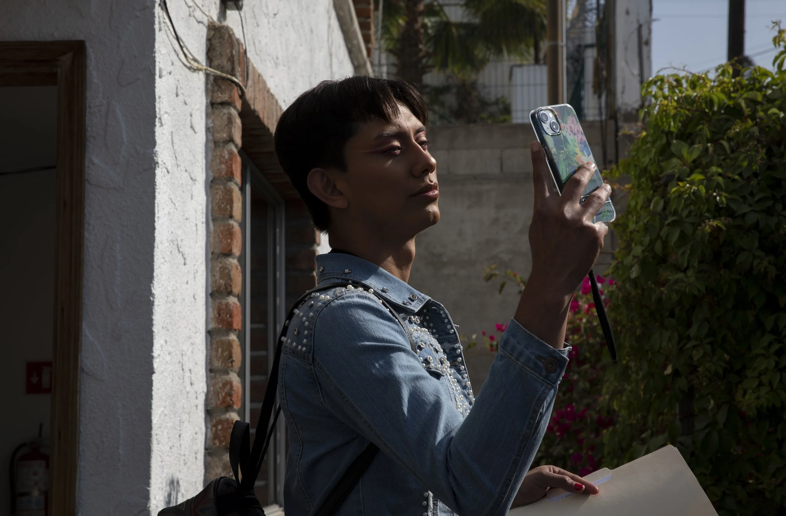  Zethare takes a selfie outside the shelter as she waits for her ride to the border. 