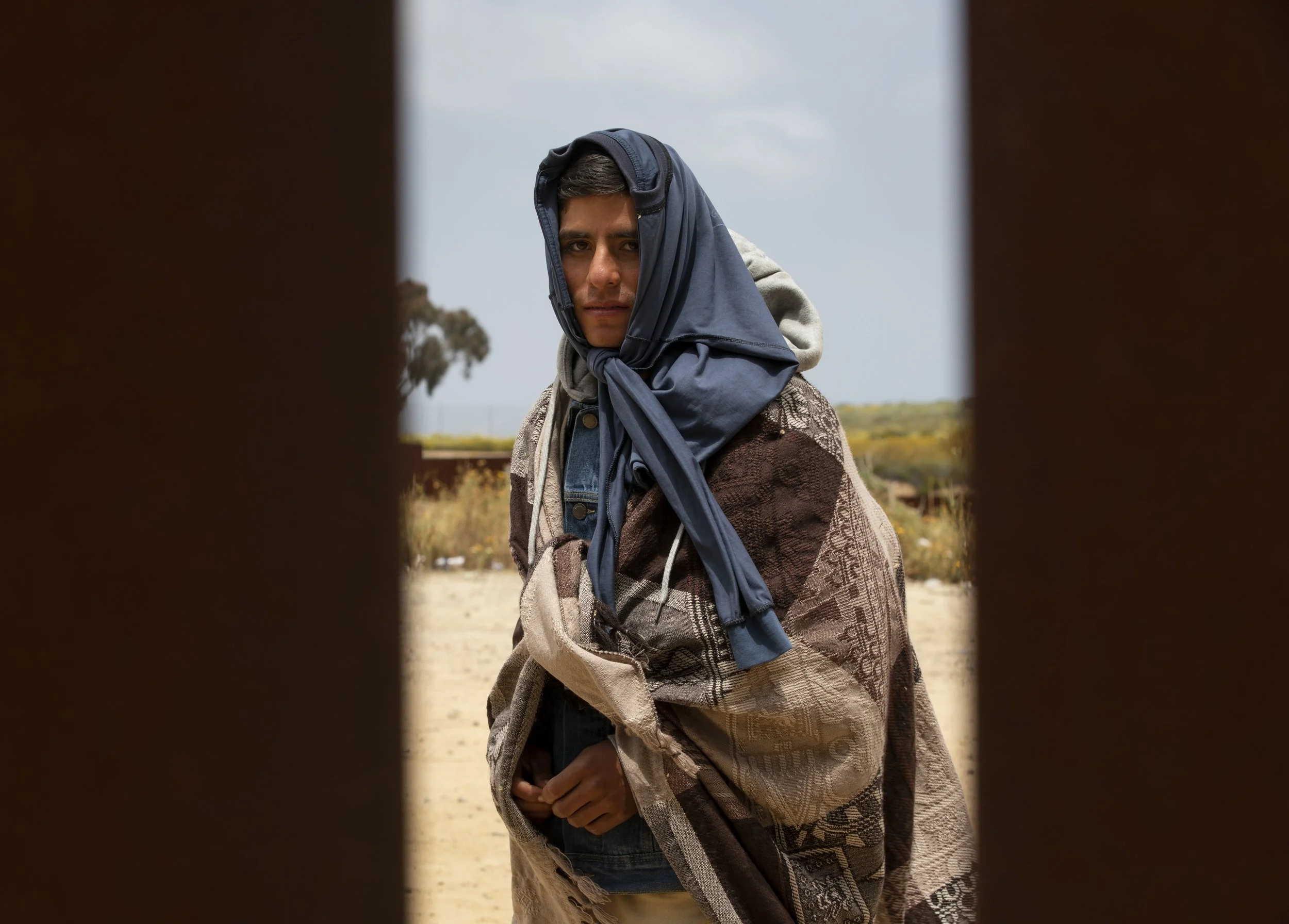  A Peruvian 23-year-old wears layers to keep warm and shaded as he waits between the border walls that separate Tijuana from San Diego with about 500-800 men traveling without their families the day after Title 42 ended on Friday, May 12, 2023 in Tij