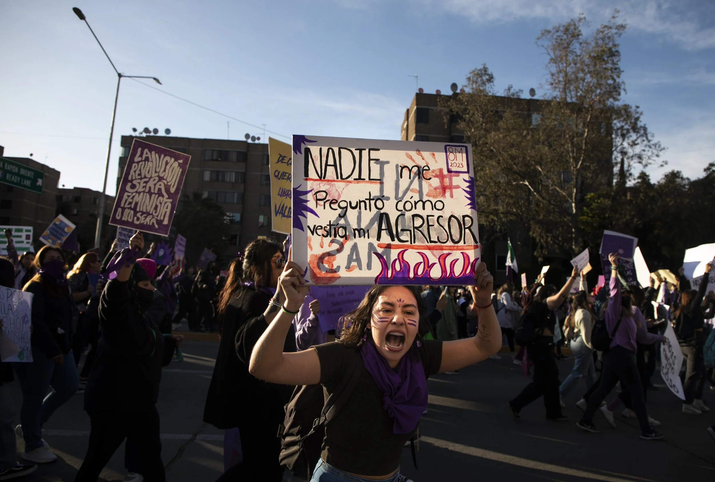 A woman holds a sign shouting at police during a march on Wednesday, March 8, 2023 in Tijuana, Baja California. More than a thousand women marched through the streets holding signs and chanting to end femicide and other abuses. The event began at Mo