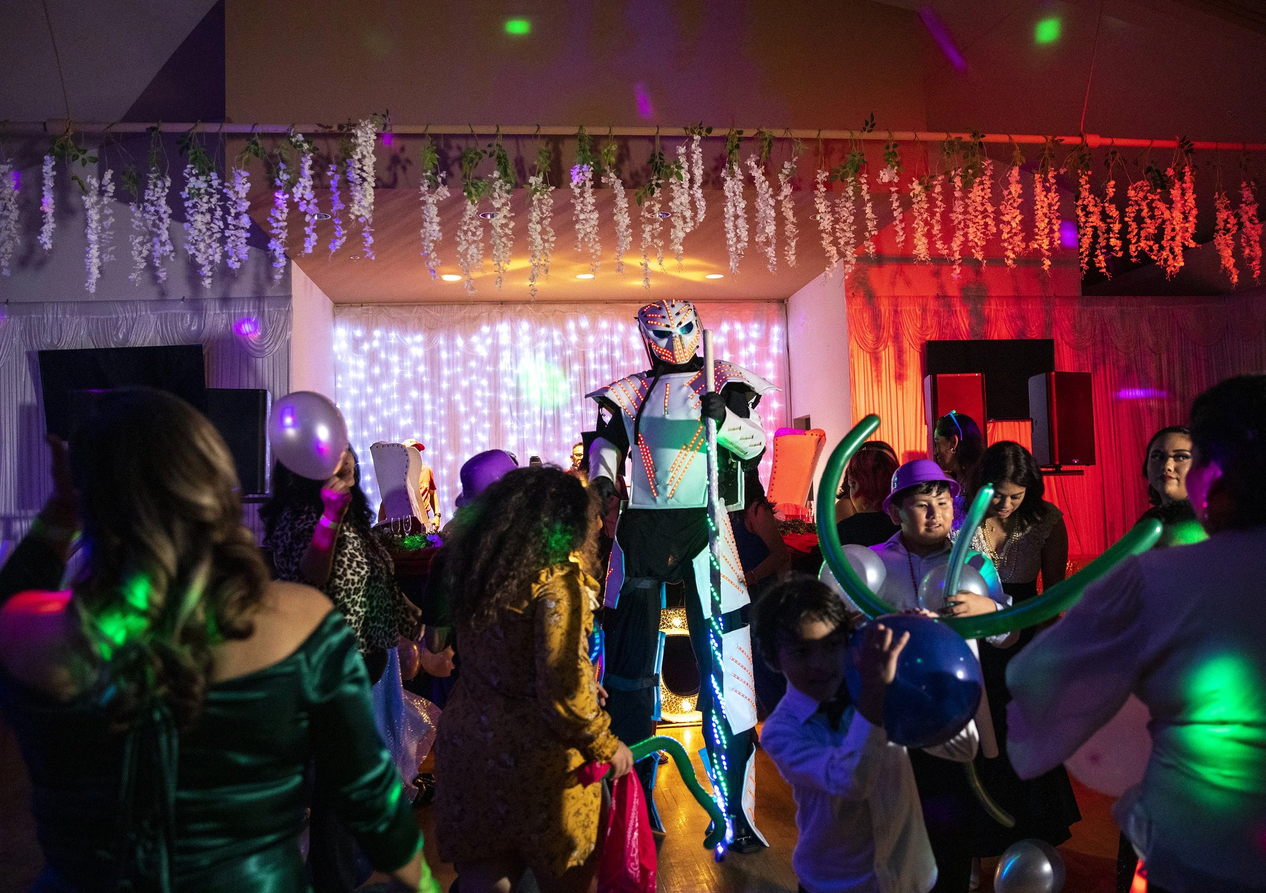   A robot surprises guests with balloons during a Twilight themed quinceañera at the Silverado Ballroom on Saturday, Oct. 22, 2022 in San Diego, CA. 